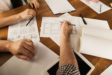 Image showing Male architect-engineer presents project of future house for young family.