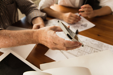 Image showing Male architect-engineer presents project of future house for young family.