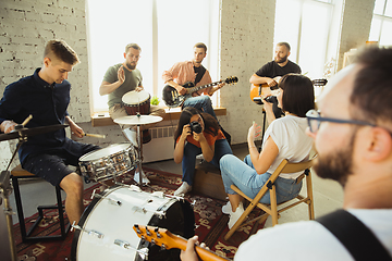 Image showing Musician band jamming together in art workplace with instruments