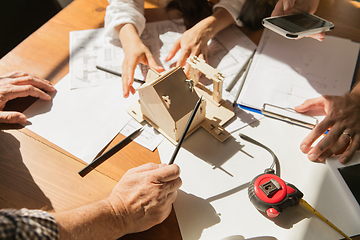 Image showing Male architect-engineer presents project of future house for young family.