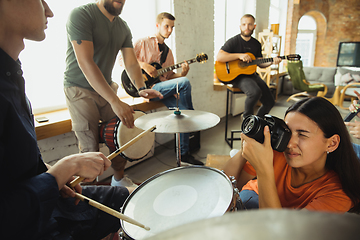 Image showing Musician band jamming together in art workplace with instruments