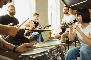 Image showing Musician band jamming together in art workplace with instruments