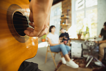 Image showing Musician band jamming together in art workplace with instruments