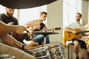 Image showing Musician band jamming together in art workplace with instruments