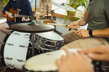 Image showing Musician band jamming together in art workplace with instruments