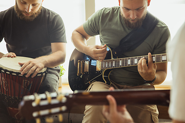 Image showing Musician band jamming together in art workplace with instruments