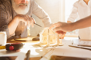 Image showing Male architect-engineer presents project of future house for young family.