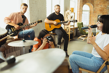 Image showing Musician band jamming together in art workplace with instruments