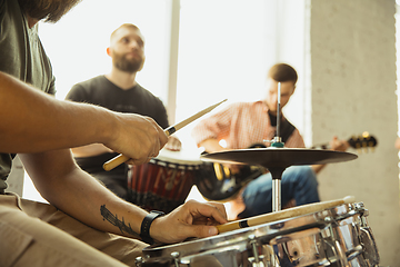 Image showing Musician band jamming together in art workplace with instruments