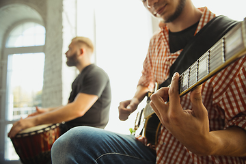 Image showing Musician band jamming together in art workplace with instruments