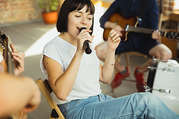 Image showing Musician band jamming together in art workplace with instruments