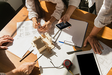 Image showing Male architect-engineer presents project of future house for young family.