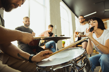 Image showing Musician band jamming together in art workplace with instruments