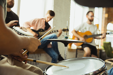 Image showing Musician band jamming together in art workplace with instruments