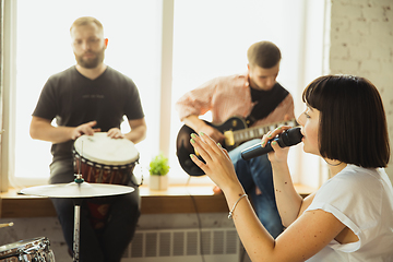 Image showing Musician band jamming together in art workplace with instruments