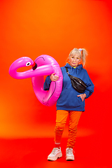 Image showing Senior woman in ultra trendy attire isolated on bright orange background