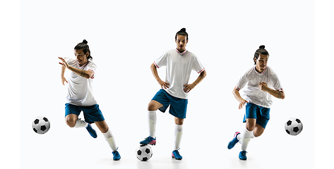 Image showing Confident football player in motion and action isolated on white background, kicking ball in dynamic