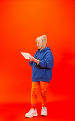 Image showing Senior woman in ultra trendy attire isolated on bright orange background