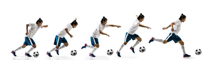 Image showing Confident football player in motion and action isolated on white background, kicking ball in dynamic