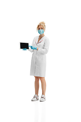 Image showing Portrait of female doctor, nurse or cosmetologist in white uniform and blue gloves over white background