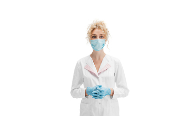 Image showing Portrait of female doctor, nurse or cosmetologist in white uniform and blue gloves over white background