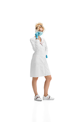 Image showing Portrait of female doctor, nurse or cosmetologist in white uniform and blue gloves over white background