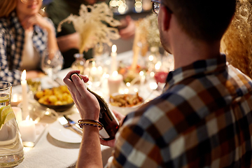 Image showing happy friends with red wine at christmas party