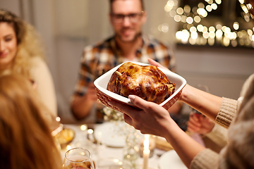 Image showing happy friends having christmas dinner at home