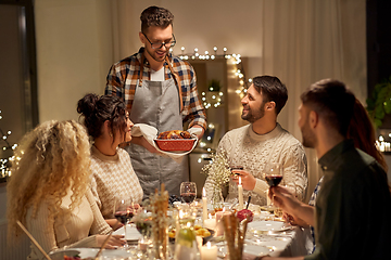 Image showing happy friends having christmas dinner at home