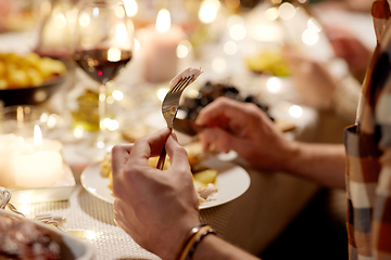 Image showing man with fork eating at christmas dinner at home