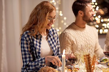 Image showing happy friends having christmas dinner at home