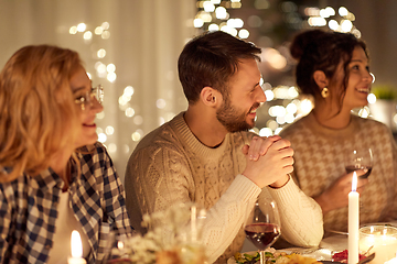 Image showing happy friends having christmas dinner at home