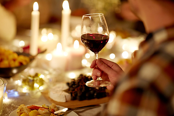 Image showing friends drinking red wine at christmas party