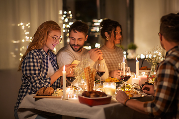 Image showing friends with cellphone having dinner party at home