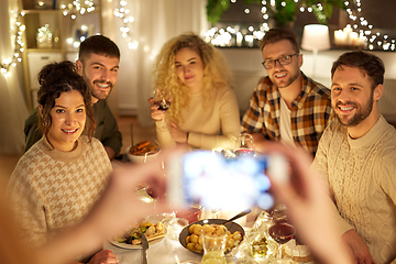 Image showing friends photographing at christmas dinner party