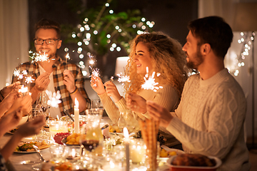 Image showing happy friends having christmas dinner at home