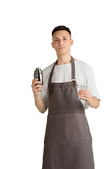 Image showing Isolated portrait of a young male caucasian barista or bartender in brown apron smiling