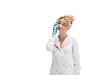 Image showing Portrait of female doctor, nurse or cosmetologist in white uniform and blue gloves over white background