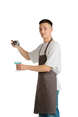 Image showing Isolated portrait of a young male caucasian barista or bartender in brown apron smiling