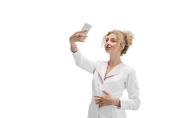 Image showing Portrait of female doctor, nurse or cosmetologist in white uniform and blue gloves over white background