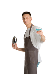 Image showing Isolated portrait of a young male caucasian barista or bartender in brown apron smiling