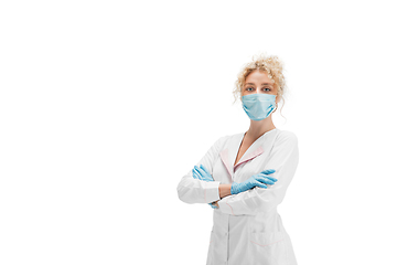 Image showing Portrait of female doctor, nurse or cosmetologist in white uniform and blue gloves over white background