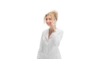 Image showing Portrait of female doctor, nurse or cosmetologist in white uniform and blue gloves over white background