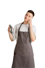 Image showing Isolated portrait of a young male caucasian barista or bartender in brown apron smiling