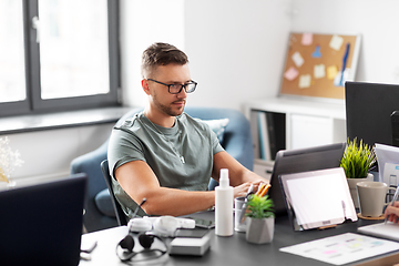 Image showing man with laptop computer working at office