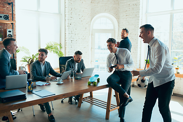 Image showing Happy colleagues having fun in office while their colleagues working hard