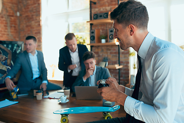 Image showing Happy colleagues having fun in office while their colleagues working hard