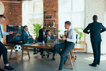 Image showing Happy colleagues having fun in office while their colleagues working hard