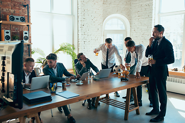 Image showing Happy colleagues having fun in office while their colleagues working hard