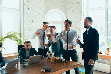 Image showing Happy colleagues having fun in office while their colleagues working hard